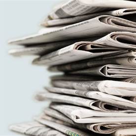 A stack of newspapers on a table

AI-generated content may be incorrect.